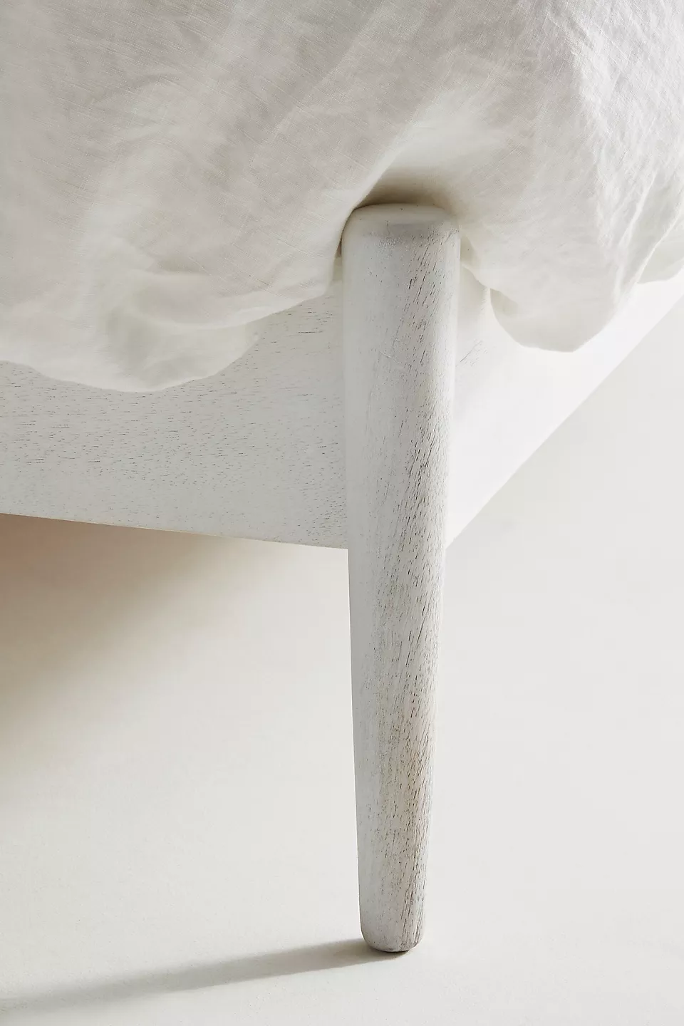 A white wooden bed frame.