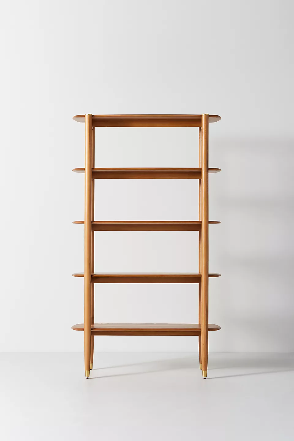A wooden shelf. A wooden bookshelf. A wooden shelving unit.