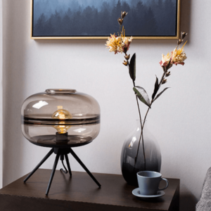 A black table lamp. A tinted glass table lamp.