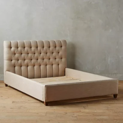 A bed with a tufted headboard and foot-board.