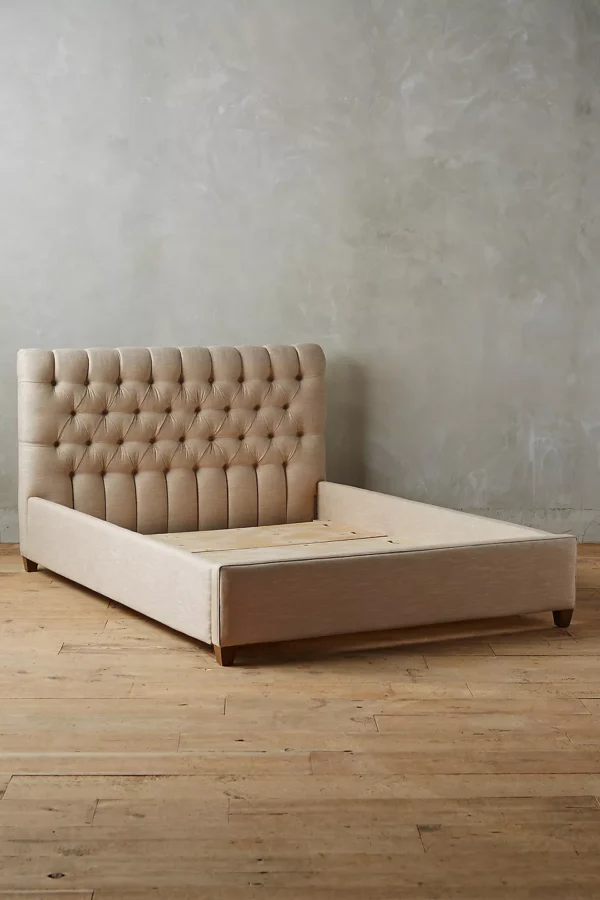 A bed with a tufted headboard and foot-board.