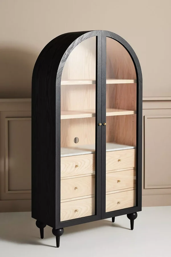 A wooden storage cabinet. An arched wood cabinet.