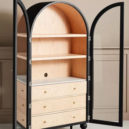 A wooden storage cabinet. An arched wood cabinet.