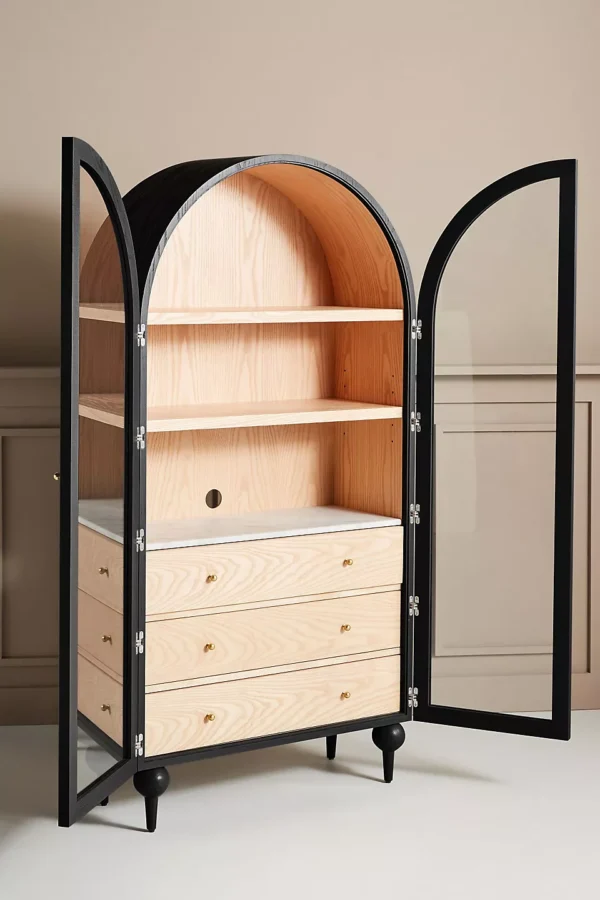 A wooden storage cabinet. An arched wood cabinet.