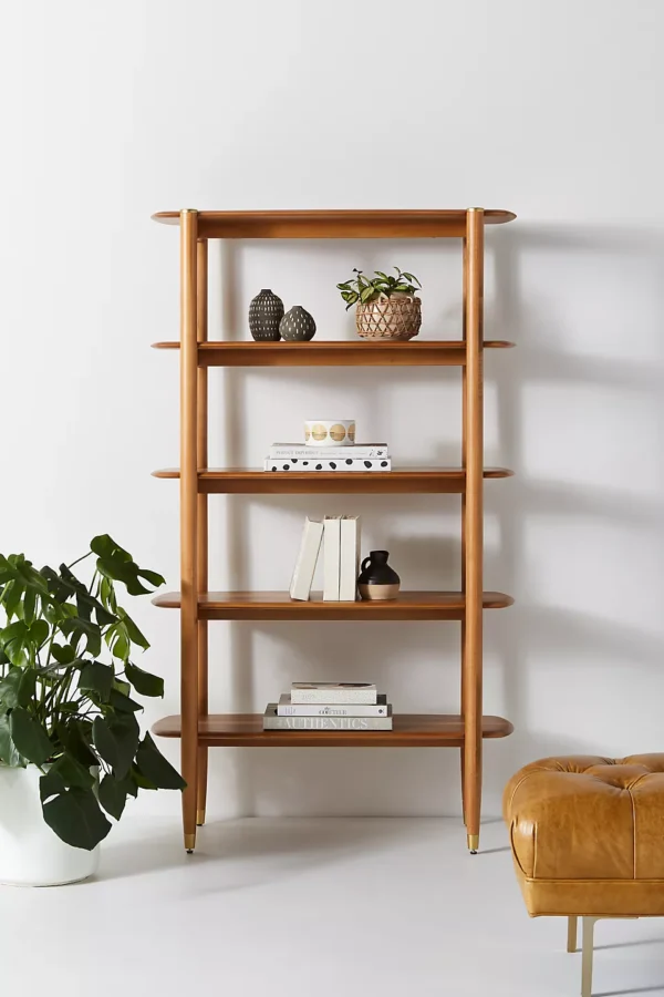 A wooden shelf. A wooden bookshelf. A wooden shelving unit.