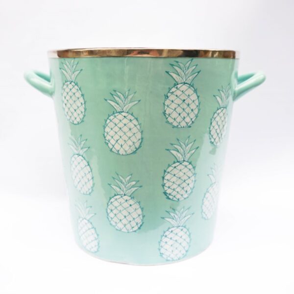 A white and green ceramic ice bucket.