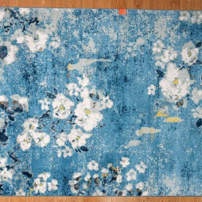 A blue rug with white flowers.