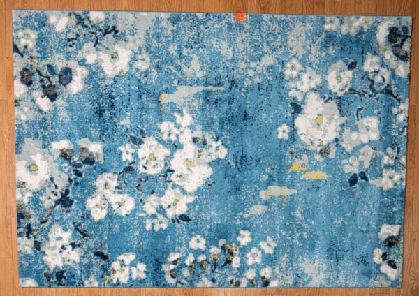 A blue rug with white flowers.