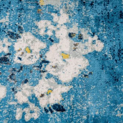 A blue rug with white flowers.