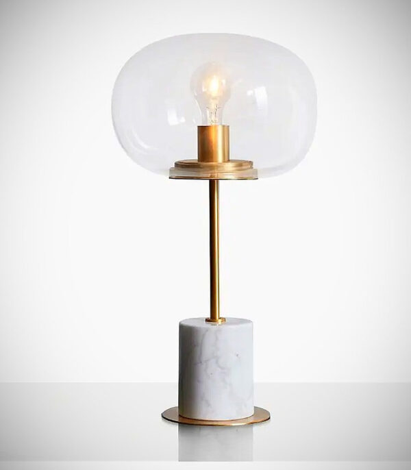 A white marble and gold table lamp.