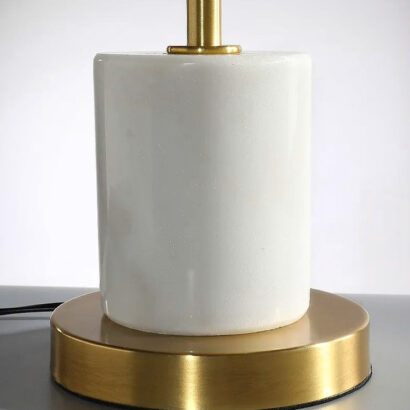 A white marble and gold table lamp.