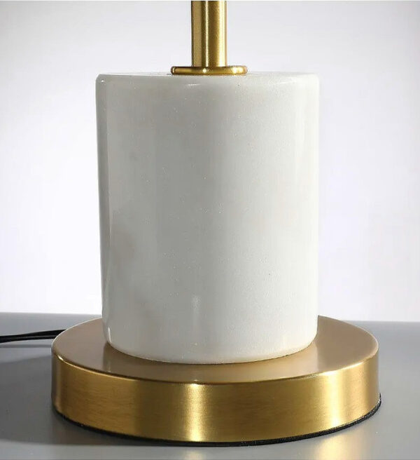 A white marble and gold table lamp.