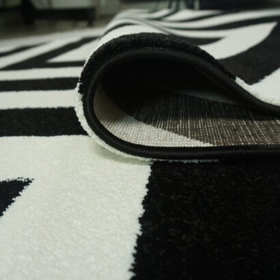 A white and black zigzag rug.