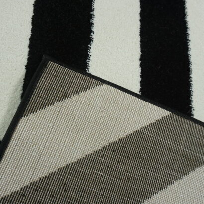 A white and black zigzag rug.