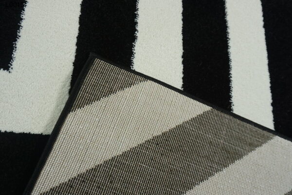 A white and black zigzag rug.