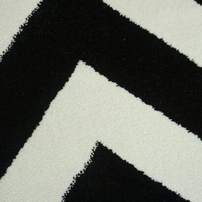 A white and black zigzag rug.