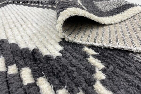 A black and white rug with diamond patterns.