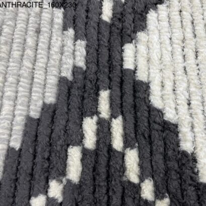 A black and white rug with diamond patterns.