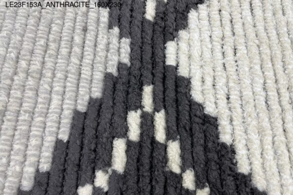 A black and white rug with diamond patterns.